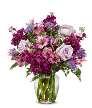 A bouquet of lavender roses, purple alstroemeria and statice, with fresh floral greens, in a clear glass vase Ready deliveryy to Illinois